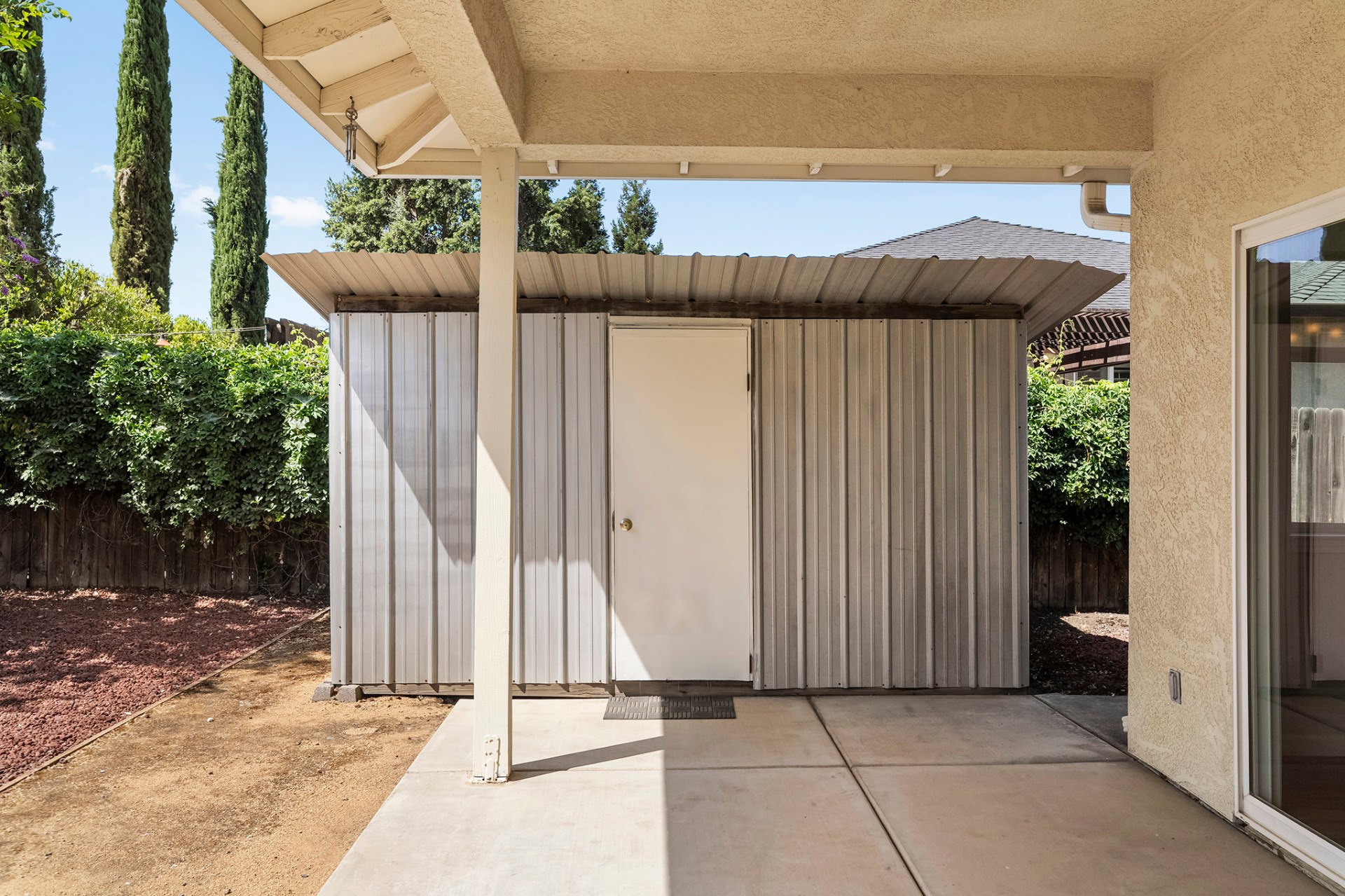 Backyard storage shed under patio cover