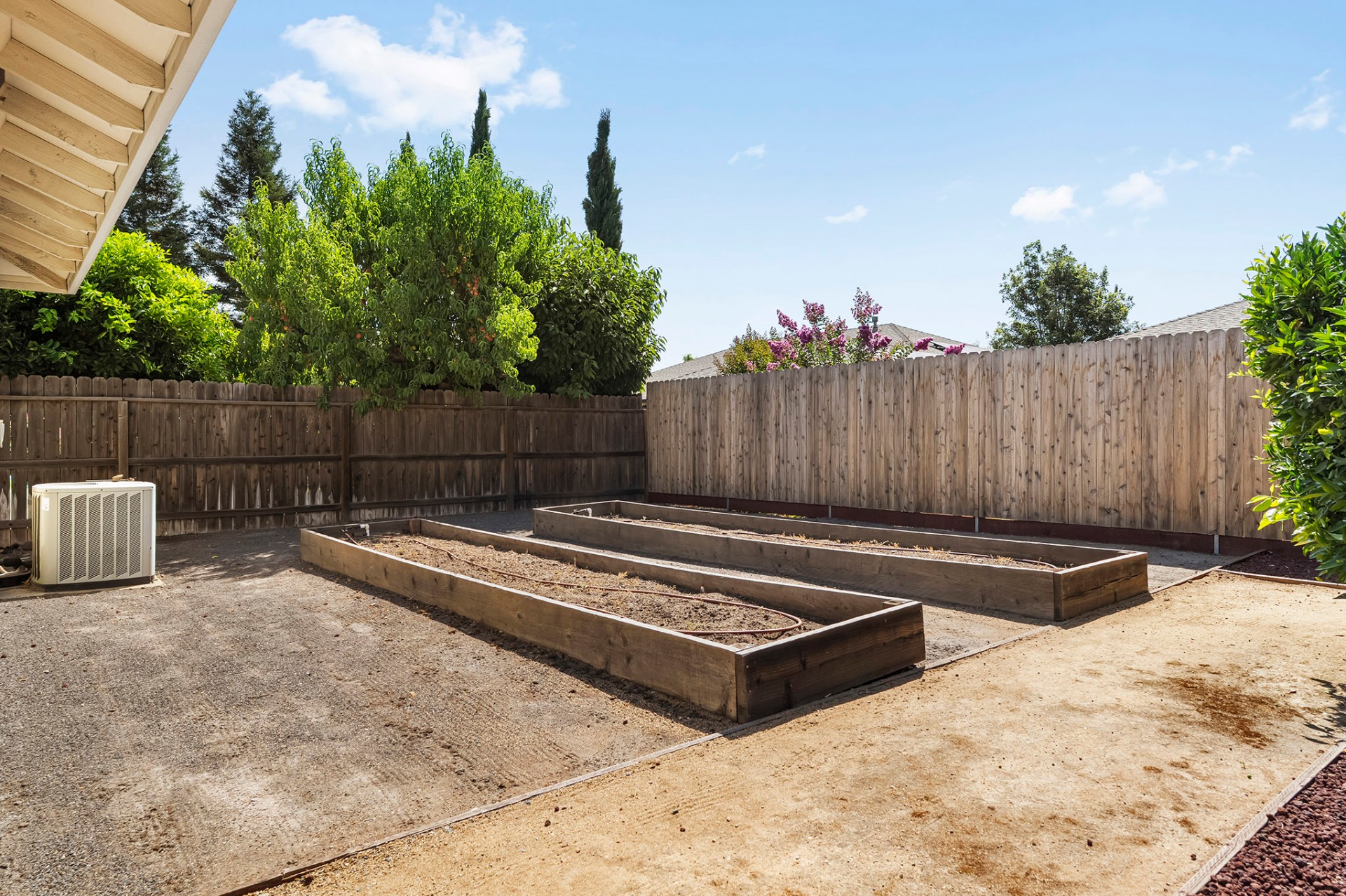 Raised garden beds along back fence